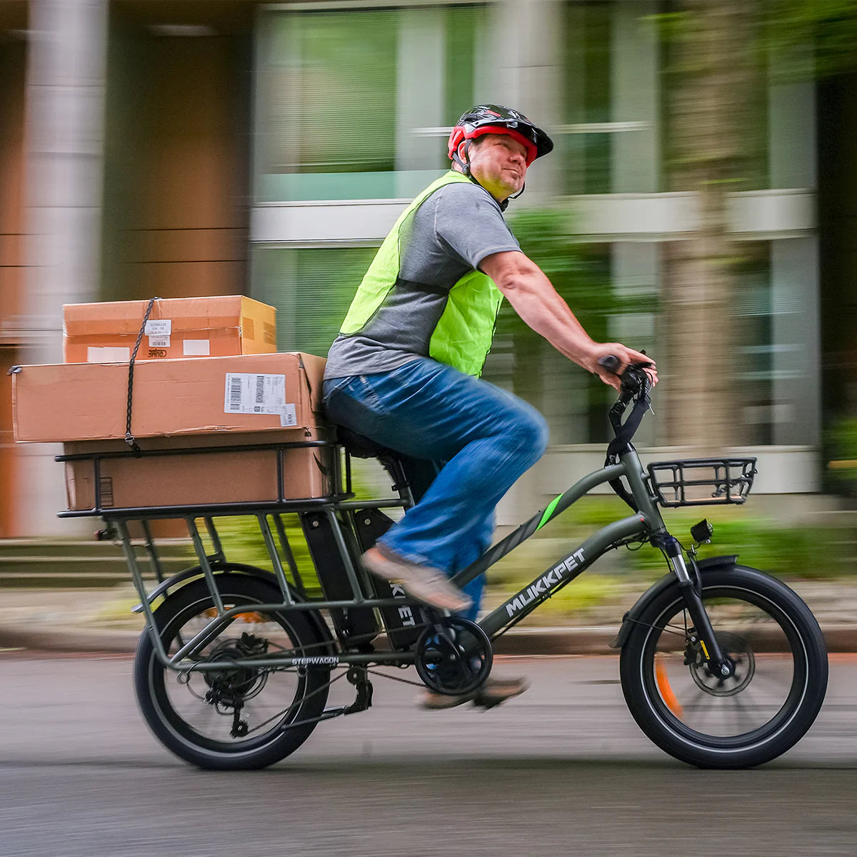 Person riding a Mukkpet cargo electric  bike with packages